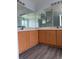 A spacious bathroom vanity area with wood cabinets, double sinks, and large mirrors at 1117 Cambourne Dr, Kissimmee, FL 34758