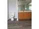 Bathroom with wood cabinets, toilet and vinyl floors at 1117 Cambourne Dr, Kissimmee, FL 34758