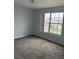 Bedroom with one window, carpeted floor, and light blue walls at 1117 Cambourne Dr, Kissimmee, FL 34758