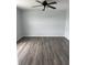 Bedroom featuring modern ceiling fan, gray walls, and vinyl plank flooring at 1117 Cambourne Dr, Kissimmee, FL 34758