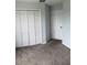 Bedroom features carpet flooring, bi-fold closet, and entry door at 1117 Cambourne Dr, Kissimmee, FL 34758