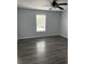 Bedroom featuring window, gray walls, and vinyl plank flooring at 1117 Cambourne Dr, Kissimmee, FL 34758