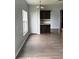 Open-concept kitchen with dark cabinets, modern lighting and light gray walls at 1117 Cambourne Dr, Kissimmee, FL 34758