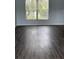 Spacious room featuring wood-look flooring, light gray walls, and a window for natural light at 1117 Cambourne Dr, Kissimmee, FL 34758
