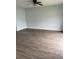 Spacious living room with gray walls and dark vinyl plank flooring at 1117 Cambourne Dr, Kissimmee, FL 34758