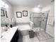 Modern bathroom featuring a dual sink vanity, soaking tub, glass shower, and decorative tile work at 11588 Whistling Pine Way, Orlando, FL 32832