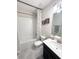 Bathroom featuring a tub-shower combo, single sink vanity, and neutral tiling at 11588 Whistling Pine Way, Orlando, FL 32832