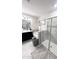 Modern bathroom featuring a dual sink vanity, soaking tub, glass shower, and decorative tile work at 11588 Whistling Pine Way, Orlando, FL 32832