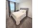Bright bedroom with a large window, neutral walls, plush carpet, and an upholstered bed at 11588 Whistling Pine Way, Orlando, FL 32832