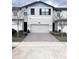 Charming two-story townhome with a two-car garage and brick-paved driveway at 11588 Whistling Pine Way, Orlando, FL 32832