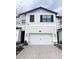 Beautiful two-story townhome with a two-car garage and paver driveway at 11588 Whistling Pine Way, Orlando, FL 32832