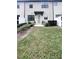 Charming two-story townhouse with manicured front yard and attractive front door at 11588 Whistling Pine Way, Orlando, FL 32832
