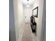 Bright hallway featuring neutral walls, tile floors, and stylish console table at 11588 Whistling Pine Way, Orlando, FL 32832