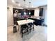 Modern kitchen with stainless steel appliances, black cabinets, a white island, and a door to the outside at 11588 Whistling Pine Way, Orlando, FL 32832