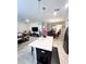 Open-concept living room and dining area featuring tile flooring, modern light fixtures and neutral color scheme at 11588 Whistling Pine Way, Orlando, FL 32832