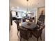 Open-concept living space with dining area, kitchen, and comfortable seating at 11588 Whistling Pine Way, Orlando, FL 32832