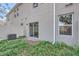 Exterior view of the backyard with a patio door and a privacy fence at 1209 S Station Pl # 306, Orlando, FL 32809