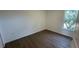 Bright bedroom with wood floors and large window at 1209 S Station Pl # 306, Orlando, FL 32827