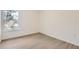 The clean bedroom offers wood-look floors and a bright window, for a serene and comfortable space at 1209 S Station Pl # 306, Orlando, FL 32809
