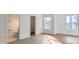 Bright bedroom with wood-look flooring, natural light, and an attached bathroom at 1209 S Station Pl # 306, Orlando, FL 32809