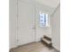 Inviting entryway featuring a white front door, wood-look flooring, and natural light at 1209 S Station Pl # 306, Orlando, FL 32809