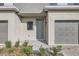 Well-maintained townhome with a gray front door, single-car garage, and lush greenery at 1209 S Station Pl # 306, Orlando, FL 32809