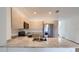 A modern kitchen featuring stainless steel appliances, granite countertops, and light wood cabinets at 1209 S Station Pl # 306, Orlando, FL 32809