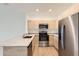 Modern kitchen with stainless steel appliances, granite countertops, and light wood cabinets at 1209 S Station Pl # 306, Orlando, FL 32809