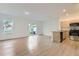 Bright, open living space with wood-look flooring and a modern kitchen at 1209 S Station Pl # 306, Orlando, FL 32809