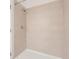 The tiled shower features modern fixtures, clean lines, and bright lighting to add to a comfortable and inviting space at 1209 S Station Pl # 306, Orlando, FL 32809