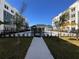 View of a community pool with a clubhouse between condo buildings at 1217 S Station Pl # 502, Orlando, FL 32809