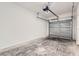Clean garage with gray concrete floors, an automatic door, and ample space at 1217 S Station Pl # 502, Orlando, FL 32809