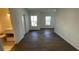 Spacious living room boasting dark wood floors, fresh paint, and natural lighting at 1217 S Station Pl # 502, Orlando, FL 32827