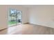 Living room with wood floors and sliding glass door to the backyard at 1217 S Station Pl # 502, Orlando, FL 32809