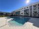 Resort-style swimming pool and spa surrounded by modern apartment buildings at 1217 S Station Pl # 502, Orlando, FL 32809