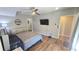 Modern bedroom featuring laminate floors, a large bed, TV, a ceiling fan, and closet space at 136 Mcleods Way, Winter Springs, FL 32708