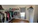 Bedroom closet featuring wire shelving with clothes hanging and wood laminate flooring at 136 Mcleods Way, Winter Springs, FL 32708