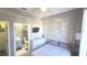 Cozy bedroom featuring a bed, dresser with TV, and ensuite bathroom at 136 Mcleods Way, Winter Springs, FL 32708