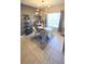 Well-lit dining room featuring a modern chandelier, neutral decor, and a window providing natural light at 136 Mcleods Way, Winter Springs, FL 32708
