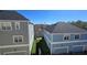 View of two-story homes with garages and manicured lawns, near a lake at 136 Mcleods Way, Winter Springs, FL 32708