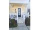 Inviting front entrance with cream siding, white trim, and manicured shrubbery at 136 Mcleods Way, Winter Springs, FL 32708