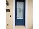 Elegant blue front door featuring decorative glass, a sleek door handle, and an electronic keypad at 136 Mcleods Way, Winter Springs, FL 32708