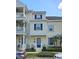 Charming townhome with cream siding, blue shutters and a well-manicured lawn at 136 Mcleods Way, Winter Springs, FL 32708