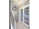 Hallway features stylish lighting, tile floors, and glass paneled doors leading to another room at 136 Mcleods Way, Winter Springs, FL 32708