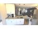 Bright kitchen with white cabinets, granite countertops, stainless steel appliances, and modern pendant lighting at 136 Mcleods Way, Winter Springs, FL 32708