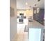Bright kitchen featuring granite countertops, stainless appliances, and modern pendant lighting at 136 Mcleods Way, Winter Springs, FL 32708