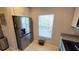 Modern kitchen featuring a stainless steel refrigerator and natural light from a nearby window at 136 Mcleods Way, Winter Springs, FL 32708