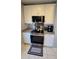 Updated kitchen features stainless steel appliances, granite countertops, and stylish white cabinetry at 136 Mcleods Way, Winter Springs, FL 32708