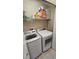 Convenient laundry room features a newer washer and dryer, plus shelving and storage space at 136 Mcleods Way, Winter Springs, FL 32708