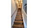 Stylish staircase with wood-look steps and white railings, enhancing the home's modern design at 136 Mcleods Way, Winter Springs, FL 32708